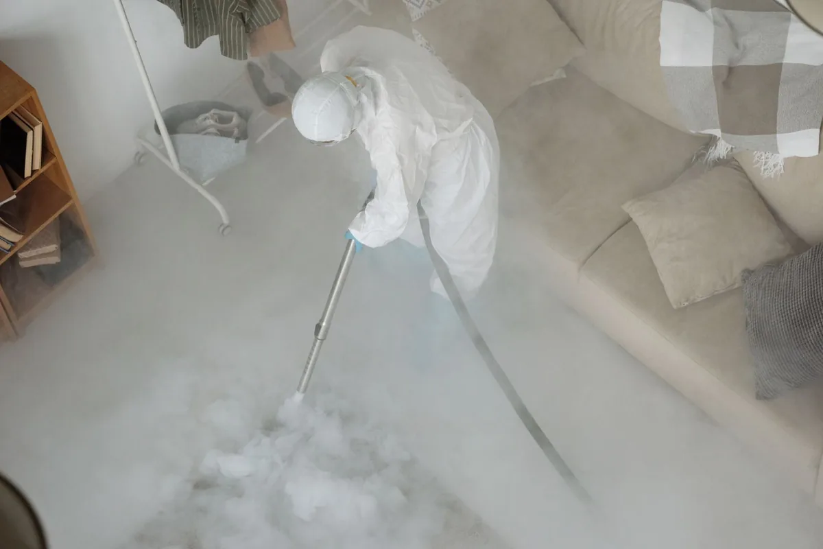 Biohazard cleanup technician in protective equipment, Glencoe, MN